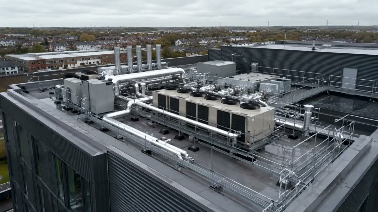 Rooftop heat network energy centre with insulated pipework on a commercial building